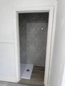 a glass door in a white room with a window at 34 Green Arbour Road in Brampton en le Morthen