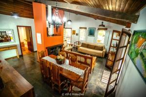 a living room with a table and a couch at Chácara Atibaia com Casa na Árvore in Atibaia