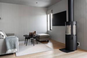 a living room with a black refrigerator and a table at Apartment Bliss in Are w. Sauna in Åre