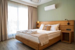 a bedroom with a large bed and a large window at Ansira Suites in Fethiye