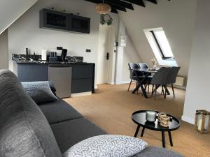 a living room with a couch and a table at GOLDEN RESORT in Boulogne-sur-Mer