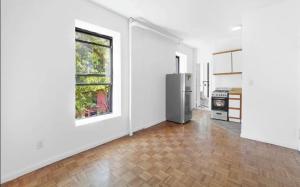 een lege keuken met witte muren en een koelkast bij 89-3FS Newly Furnished 2br 1bath UES in New York