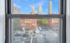 a view of a city street from a window at 89-3FS Newly Furnished 2br 1bath UES in New York