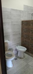 a bathroom with a toilet and a sink at Apolo in General Alvarado +2 photos
