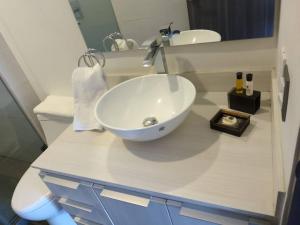 a bathroom with a white sink and a mirror at Nuevo departamento en Sonata, Blank, Lomas, puebla in Lomas de Angelopolis