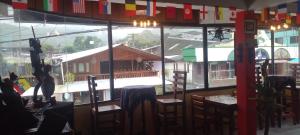 a restaurant with a view of a building from a window at Aracari Inn Mindo in Mindo