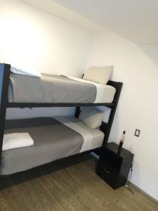 two bunk beds in a room with a wall at Nuevo departamento en Sonata, Blank, Lomas, puebla in Lomas de Angelopolis