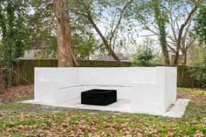 a white bench in a yard next to a tree at East Atlanta / Decatur retreat with fire-pit in Decatur