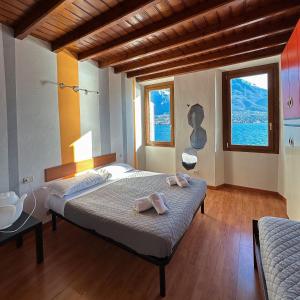 Oliveto Larioにあるrenzo e Lucia lake view apartmentのベッドルーム1室(ベッド1台、タオル2枚付)