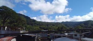 a view of a town with mountains in the background at Aracari Inn Mindo in Mindo