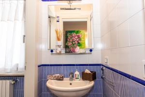 a bathroom with a sink and a mirror at Villa Orchidea in Franciacorta in Villa Pedergnano