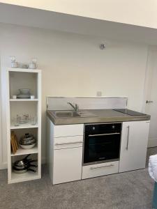 a kitchen with a sink and a counter top at 12 Plants Yard -Modern Retreat in Worksop
