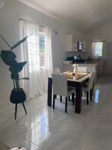 a kitchen and dining room with a table and chairs at Maison Baie Retreat in Discovery Bay