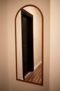 a mirror on a wall with a black door at Munir’s residence in Cairo