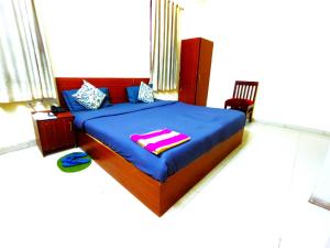 Hotel S-14 في جايبور: غرفة نوم مع سرير مع لحاف أزرق