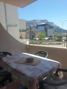 a table on a balcony with a view of a city at sunny apartments near the sandy beach in Omiš