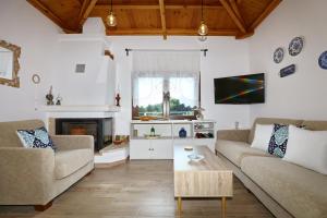 a living room with two couches and a coffee table at Diakopi Villa in Skopelos Town