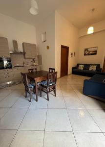a living room with a table and chairs and a couch at apartment in the center of Castellammare del Golfo in Castellammare del Golfo