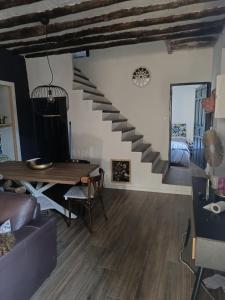 a living room with a staircase and a table at Casa Rural Puente de la Vicaria by Jaxun in Yeste