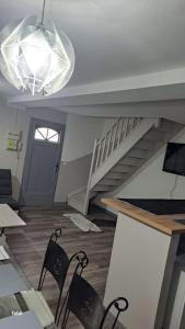a living room with two chairs and a staircase at maison pas loin centre-ville in Reims +26 photos