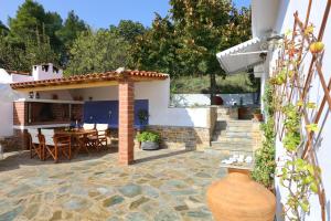 a patio with a table and a house at Diakopi Villa in Skopelos Town