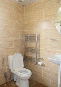a bathroom with a toilet and a sink at 3 bedroom house,4beds, 2 baths Ilford ,12 mins to Stratford in London