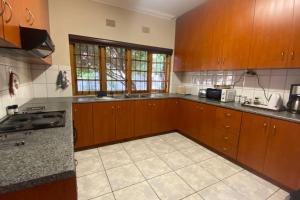 a kitchen with wooden cabinets and a counter top at Lekkalê in Robertson