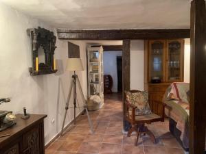 a room with a bedroom with a table and a chair at Patones de Arriba Brother Law SL in Patones