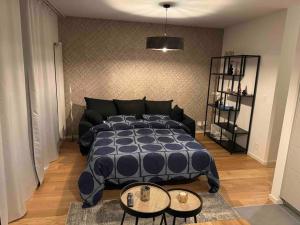 a bedroom with a large bed and two tables at Charmant Studio in Geneva