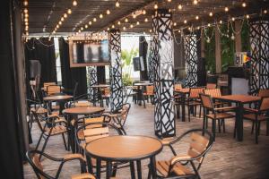 a restaurant with tables and chairs and a television at The Safron Hotel in Lagos