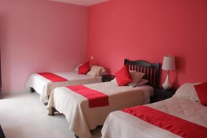 Postel nebo postele na pokoji v ubytování Hotel Boutique La Orquidea