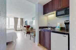 a kitchen and living room with a bed in a room at Bayside at Sandestin #6580 in Destin
