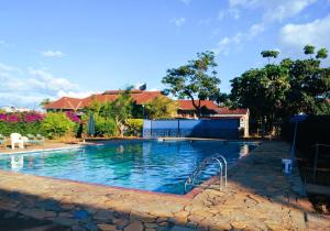 a large swimming pool with blue water at HOTEL SENATE JUJA in Thika