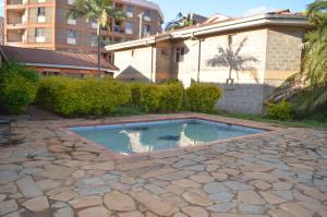 a swimming pool in the yard of a house at HOTEL SENATE JUJA in Thika
