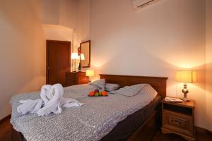 a bedroom with a bed with towels and fruit on it at Pirin Golf Mountain View Retreat in Razlog