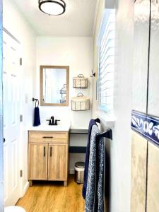 a bathroom with a sink and a mirror at Cozy Studio Cottage in Downtown Twin Falls in Twin Falls +27 photos