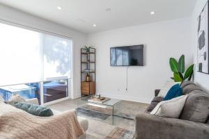 a living room with a couch and a tv at Luxury Resort Villa in Muskoka in Gravenhurst