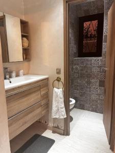 a bathroom with a sink and a toilet at Villa Al Nour avec piscine in Marrakesh