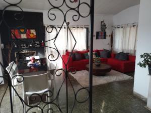 a living room with a red couch and a red chair at Alquiler temporario villa Carlos Paz in Villa Carlos Paz