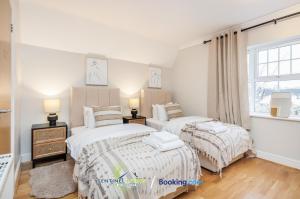 a bedroom with two beds and a window at Pet Friendly Spacious Townhouse By Sentinel Living Short Lets & Serviced Accommodation Windsor Ascot Maidenhead With Free Parking in Winkfield