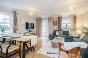 a living room with a couch and a table at Pet Friendly Spacious Townhouse By Sentinel Living Short Lets & Serviced Accommodation Windsor Ascot Maidenhead With Free Parking in Winkfield