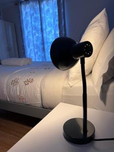 a black lamp on a table next to a bed at Luxe Heights Nest in Birmingham