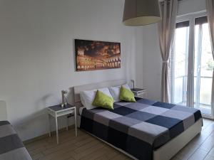 a bedroom with a bed with a blue and white at Bolognamania Apartments-Prime in Bologna