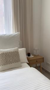 1 dormitorio con 1 cama y 1 mesa con lámpara en Traumhaftes City Apartment en Viersen