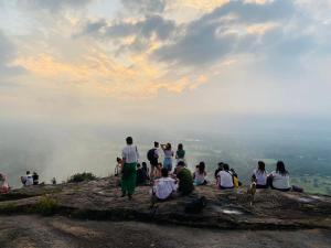 a group of people sitting on top of a mountain at Forest Villa in Sigiriya