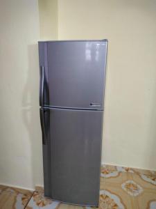 a stainless steel refrigerator in the corner of a room at Inapan Salsabila in Jitra