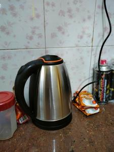 a black and silver tea kettle sitting on a counter at Inapan Salsabila in Jitra