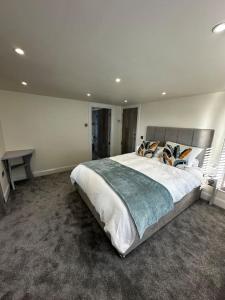 a bedroom with a large bed and a desk at Riverside Seaside Apartment in Littlehampton
