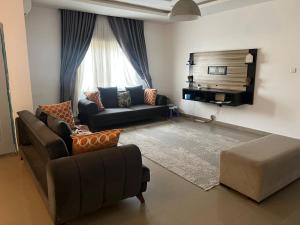 a living room with two couches and a couch at Thurayya&zaheed luxury in Abuja