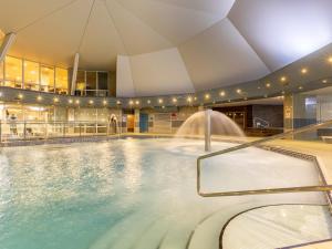 a swimming pool with a fountain in a building at 2 Bed in St. Mellion 87715 in St. Mellion